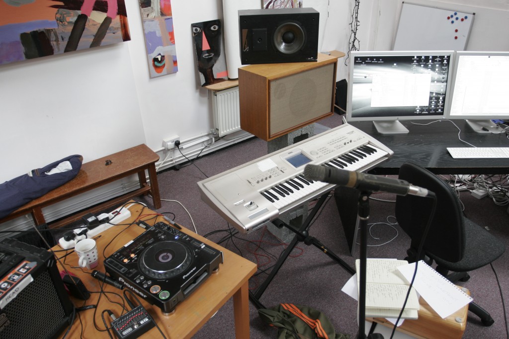In this shot, Karl's table is on the left, an Korg workstation is in the centre and the DAW monitor screen is on the right. Karl's Shure SM57 vocal mic is on the stand in the foreground